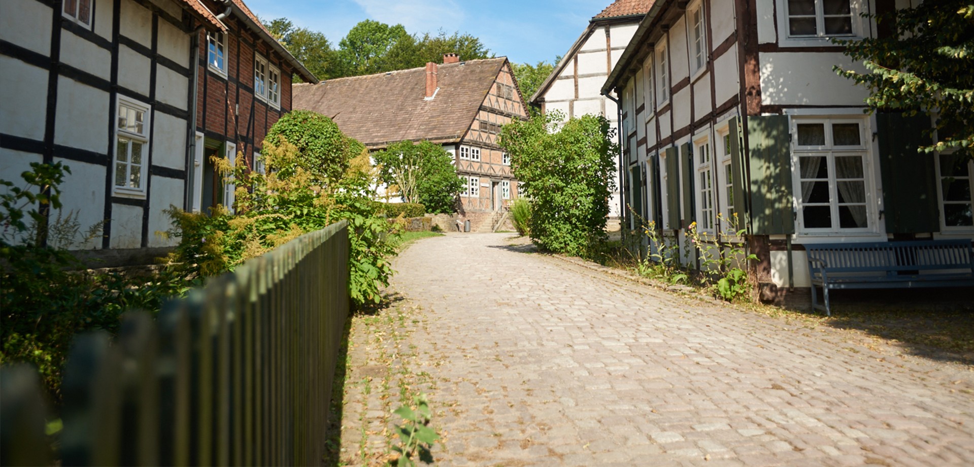 A path in the Paderborn Village between historic buildings.