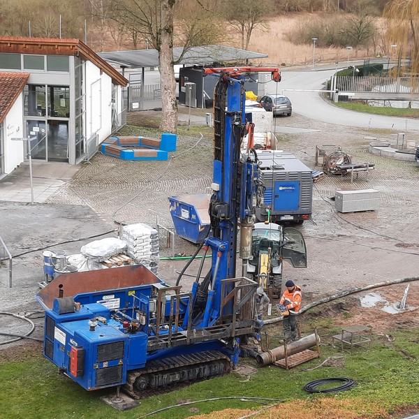 Ein Geothermiebohrer bohrt ein Loch ins Erdreich.